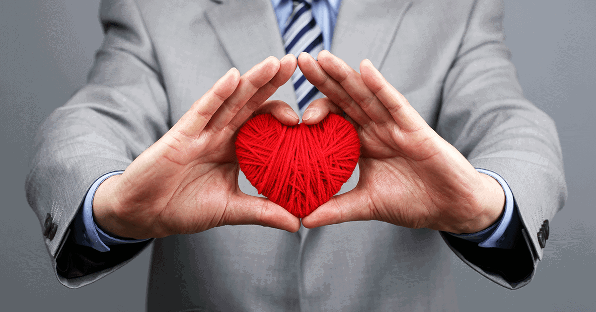 Businessman holding a yarn heart
