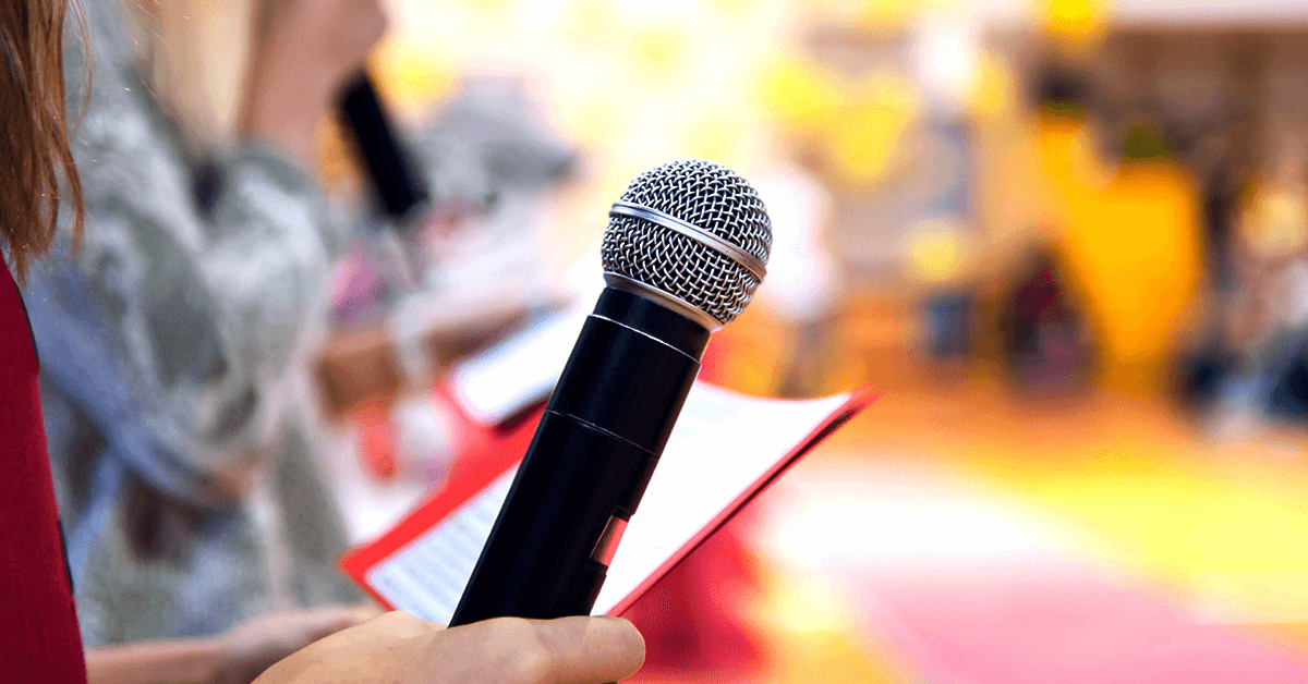 girl holding microphone preparing to give a presentation